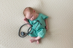newborn baby dressed in hospital scrubs with stethiscope